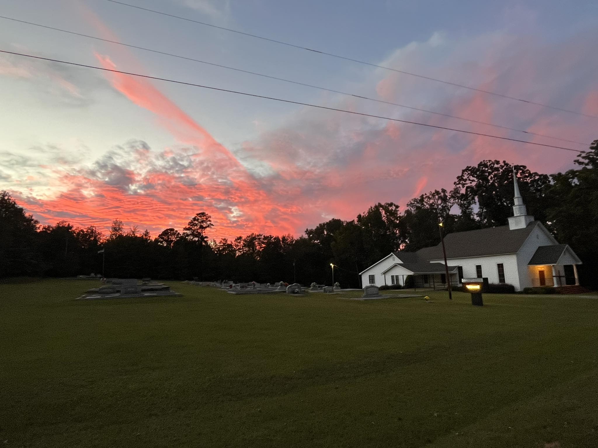 Pleasant Grove at sunset with glowing sky.